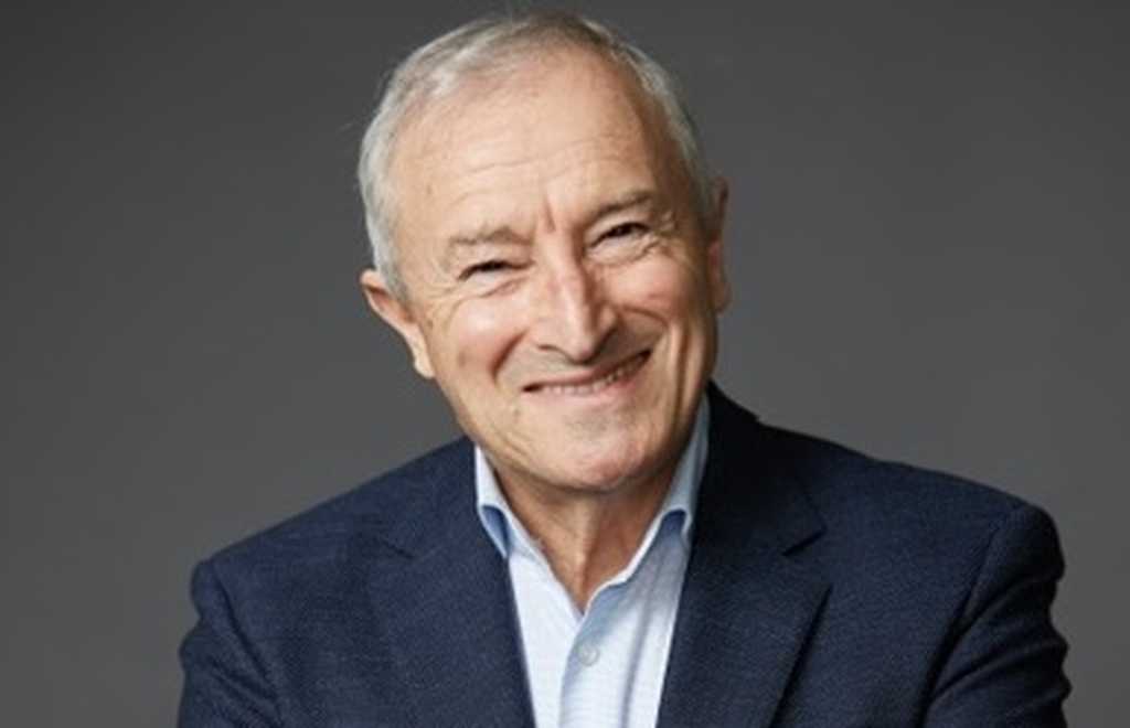 BWBF Patron Jim Rosenthal is wearing a dark suit and light shirt. He is smiling broadly.