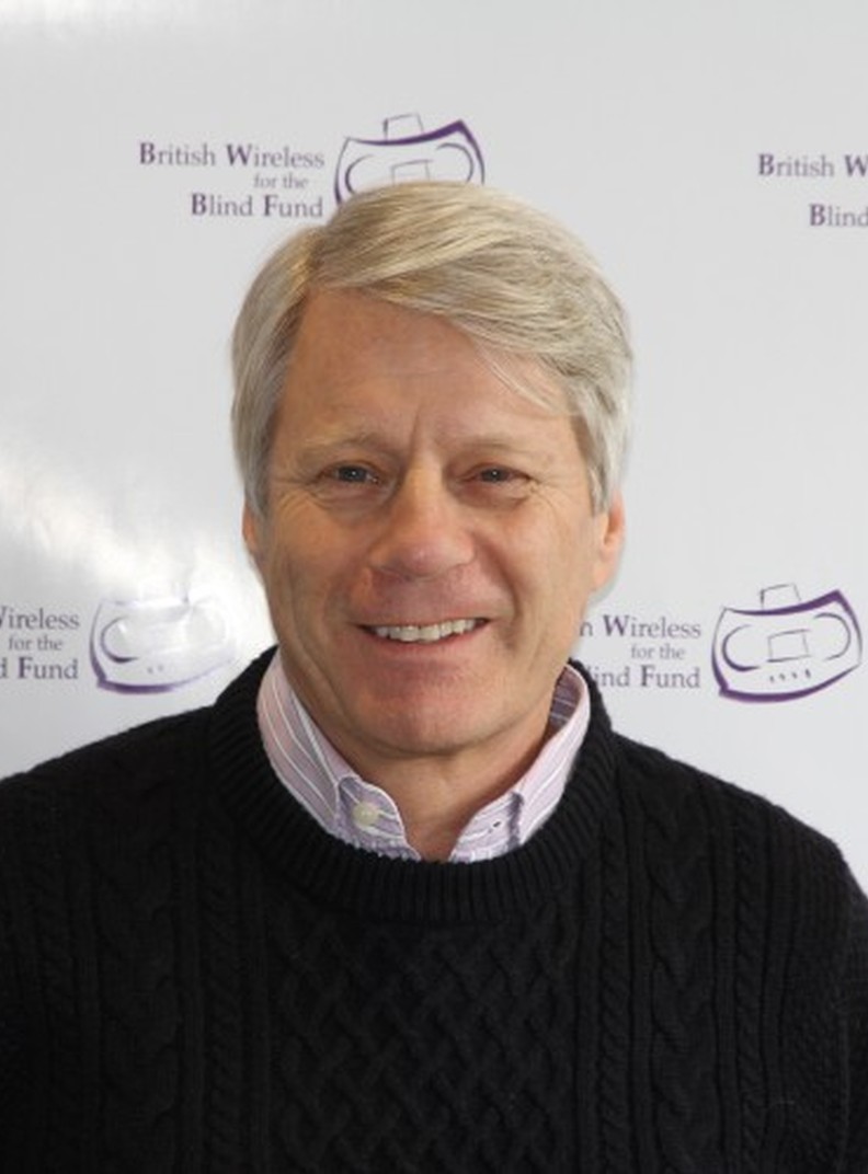 BWBF Patron Nick Ross smiles to camera. He is wearing a black jumper with a pale shirt underneath