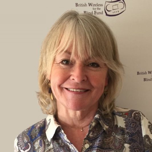 BWBF Patron Sue Cook is smiling to camera. She has blonde hair and is wearing a patterned shirt.