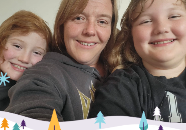 A photo from our Christmas appeal, featuring Joanna and her daughters with a festive border featuring a snowy scene and fir trees underneath.