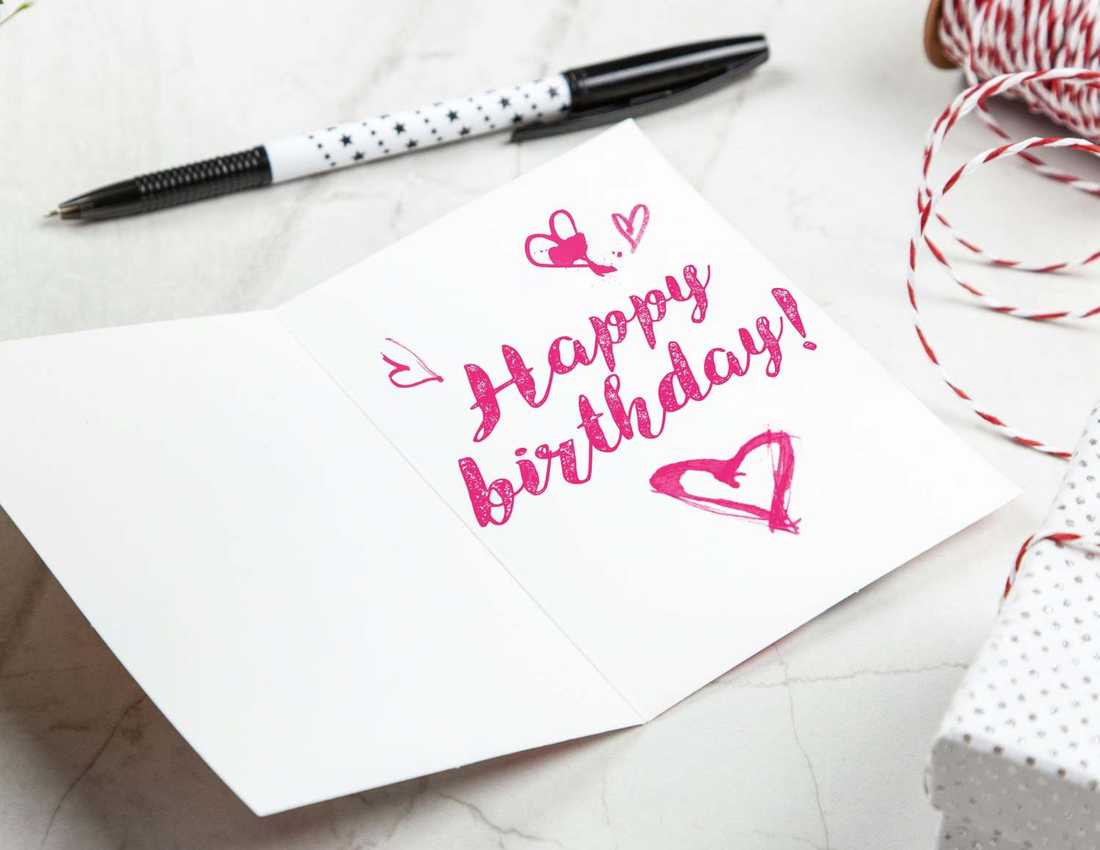 Inside of a birthday card which says Happy Birthday in pink writing